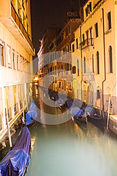 Venice, Italy, January 27, 2020 gondolas moored along ancient dwellings in a canal