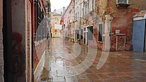 VENICE, Italy - May 2019: traditional street in Italy. Wet asphalt after rain. Slow motion