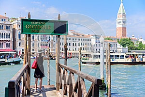 VENICE, ITALY - MAY, 2017: girl tourist standing on the pier in the background of the panorama of Venice