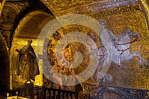 Golden wall mosaic inside San Marco or St Mark`s Basilica, it is great old landmark of Venice