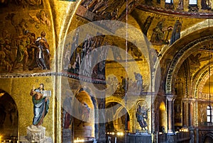 Golden wall mosaic inside San Marco or St Mark`s Basilica, it is old landmark of Venice. Interior of famous St Mark`s cathedral