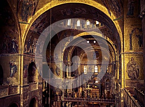 Inside famous San Marco or St Mark`s Basilica, it is top tourist attraction of Venice. Golden mosaic interior of ornate San Marco