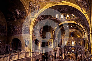 Inside the old St Mark`s Basilica or San Marco, it is top landmark of Venice. Golden mosaic interior of ornate Saint Mark`s