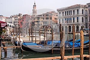 Venice, Italy - October 13, 2017: Gondolas in Venice. The gondolas are moored at the mooring posts.