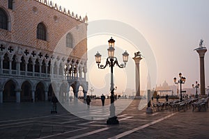 VENICE, ITALY - OCTOBER 06, 2017:  Tourits on the San Marco square at sunrise