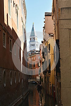 Venice, Italy, October 2021: View of a narrow canal surrounded by old brick houses.