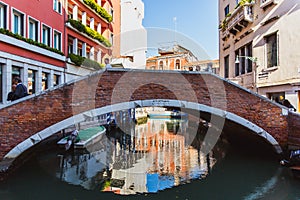 VENICE, ITALY - OKTOBER 27, 2016: colorful corners with old classic buildings, small bridge and little water canal in Venice,