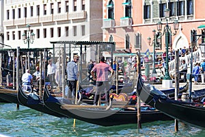 Venetian gondoliers at the marina of the gondolas, Grand Canal.Venice, Italy