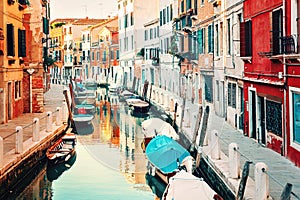 Venice, Italy. Small canal with boats and old historic buildings.