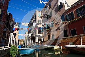 Venice Italy street with laundry washed clothes hanging out to dry on ropes between houses