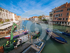 Venice, Italy - 17.10.2023: View on different boats moving in Grand Canal, busy unique city life. Warm sunny day with blue cloudy