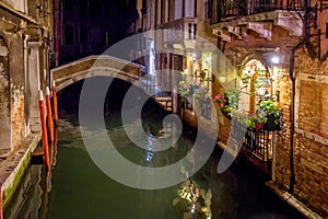 Venice at night, Italy. Beautiful narrow canal with bridge and vintage houses