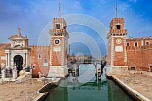 Venice. Old stone towers of the arsenal over the canal on a sunny day.