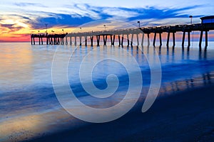 Venice pier, Florida, at sunset with intentionally blurry waves to show motions and beauty