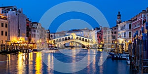 Venice Rialto bridge over Canal Grande with gondola travel traveling holidays vacation town panorama at night in Italy