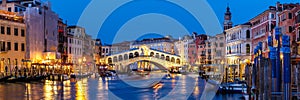 Venice Rialto bridge over Canal Grande with gondola travel traveling holidays vacation town panorama at night in Italy