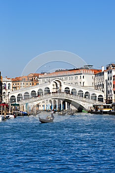 Venice Rialto bridge over Canal Grande with gondola travel traveling holidays vacation town portrait format in Italy