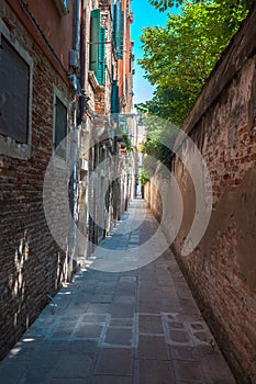 Venice`s narrowest street between brick walls, Italy