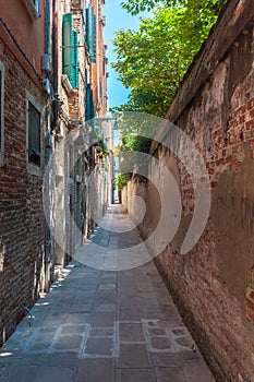 Venice`s narrowest street between brick walls, Italy