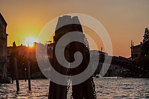 Venice - Silhouette of wooden pile and bridge during the sunset over Grand Canal in Venice