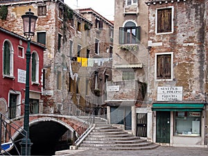 Venice street and footbridge crossing the canal in san polo