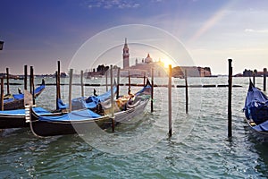 Venice. A sunset over the channel Grande and gondolas at the mooring