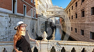 Venice - Tourist woman with had and sunglasses under the Bridge of Sighs in Venice