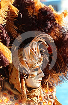 Venice, VE, Italy - February 13, 2024: Mask at the Venetian Carnival with feathered headdress