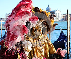 Venice, VE, Italy - February 13, 2024: Venetian Mask at the Venice Carnival and sea of lagoon