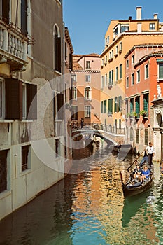 VENICE, VENETO, ITALY - Tourists, gondola riding, typical canal in Venice, September 21, 2017