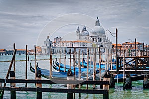 Venice view on Santa Maria della Salute basilica and gondolas on the Grand canal. Famous tourist attraction, summer city