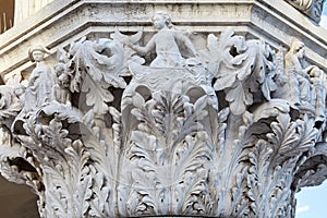 Venice, white capital sculpture with woman, boat and crab, Italy