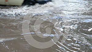 Venicles moving through road after heavy downpour with deep water