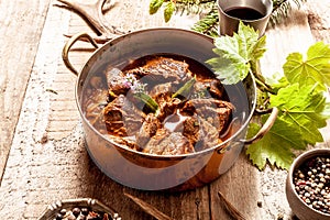 Venison Goulash in Copper Pot on Wooden Surface