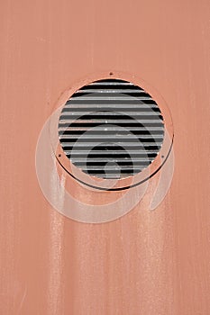 The ventilation hole on the brown-colored wall