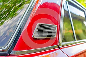 Ventilation from the outside on a Lada car. Close-up of the ventilation grill on the red car