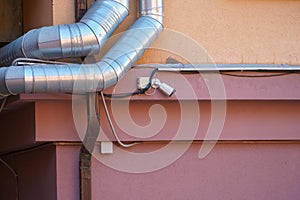 Ventilation pipes on the facade of the building. Metal pipes covered with a thermal shell in the ventilation system of the