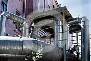 Ventilation pipes on the wall of the building outside the old Industrial building of the factory