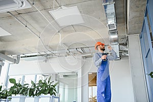 ventilation system installation and repair service. hvac technician at work. banner copy space.