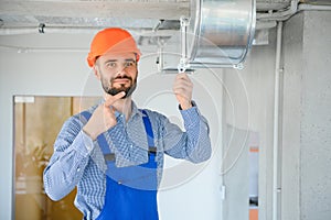 ventilation system installation and repair service. hvac technician at work. banner copy space.