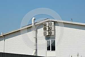 Ventilation system on siding house construction with air compresors and chimney