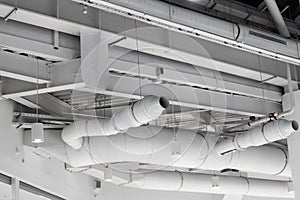 ventilation system under ceiling of modern warehouse or shopping center. Metal piping for air conditioning