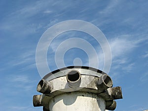 Ventilation tube of a bomb shelter against blue sky