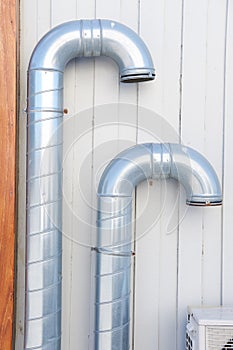 Ventilation. Ventilation pipes on a building wall. Equipment for fresh air and architecture. Two metal tubes used in the