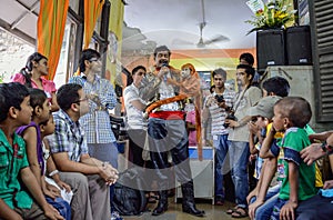 A Ventriloquist performing an act for children