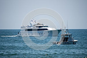 The luxury motor super yacht `Surfrider` arrives at port in front of the Harbor Patrol boat.