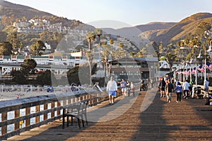 Ventura, California, United States - June 24 2012: People walking along Ventura Pier at sunset