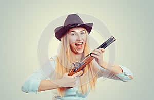 Woman in cowboy hat holding gun photo
