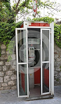 Venzone, UD, Italy - April 22, 2019: old Italian phone booth wit