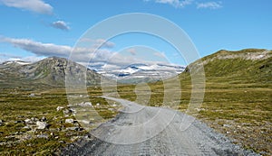 Veodalsvegen ground road in the direction of Jotunheimen mountain area, Glittertind mountain is visible in center. Norway